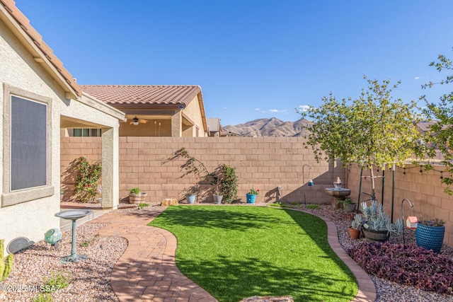 view of yard featuring a mountain view and a fenced backyard