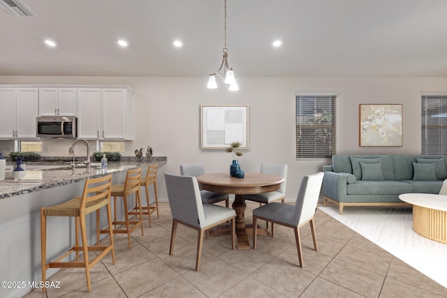 dining space with light tile patterned flooring, visible vents, and recessed lighting