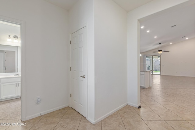 hall with recessed lighting, baseboards, light tile patterned flooring, and vaulted ceiling