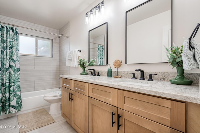 full bathroom featuring double vanity, toilet, shower / bathtub combination with curtain, and a sink