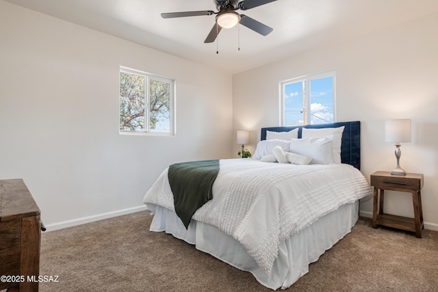 bedroom with multiple windows, carpet flooring, baseboards, and ceiling fan