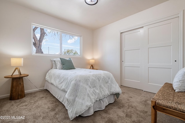 bedroom featuring a closet, carpet floors, and baseboards