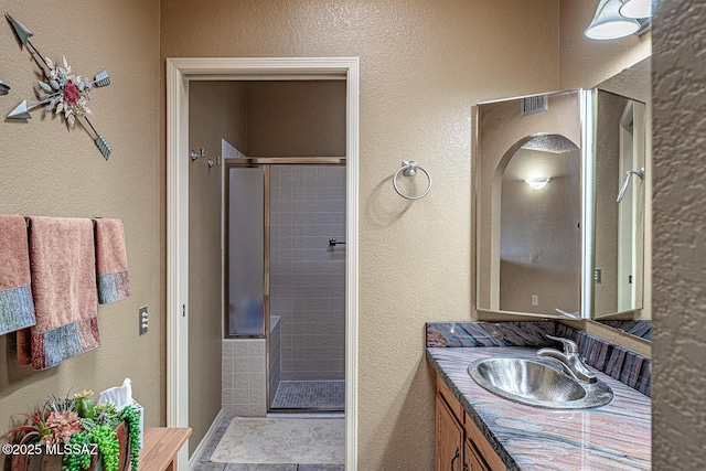 full bathroom with vanity and a shower stall