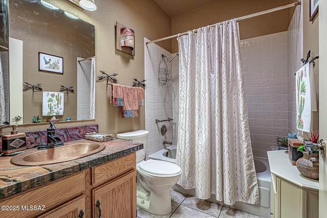 bathroom featuring shower / tub combo with curtain, toilet, tile patterned flooring, vanity, and a textured wall