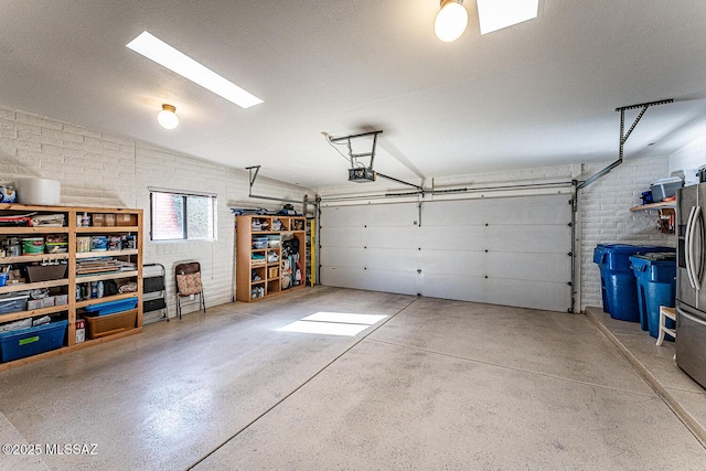 garage with a garage door opener and freestanding refrigerator