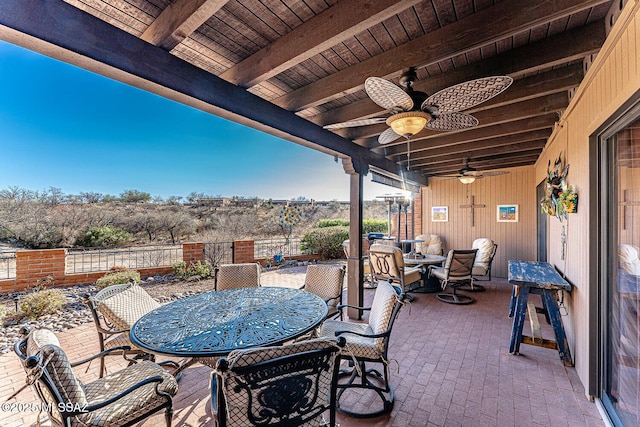 view of patio / terrace with outdoor dining area, fence, and ceiling fan