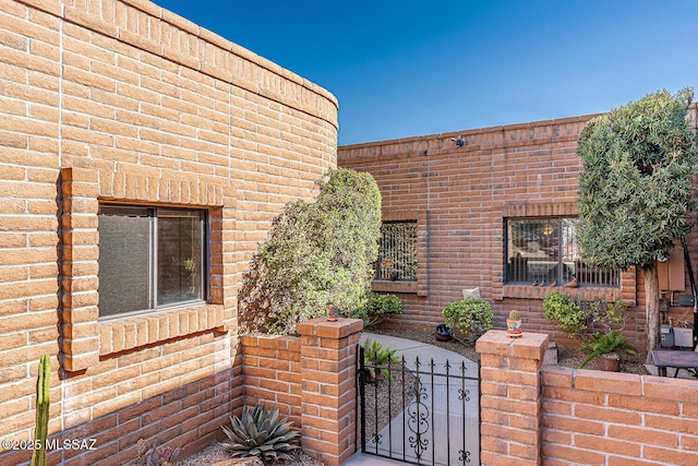 view of home's exterior with a gate and a fenced front yard