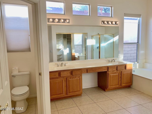 full bath featuring tile patterned floors, toilet, a stall shower, a sink, and a bath