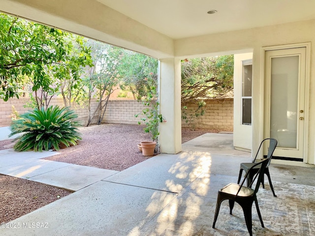 view of patio / terrace featuring fence