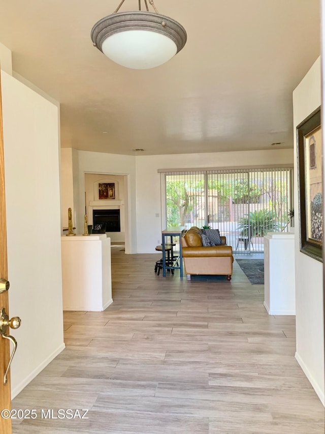 hallway with baseboards and wood finished floors