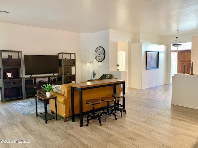 living room featuring visible vents and wood finished floors