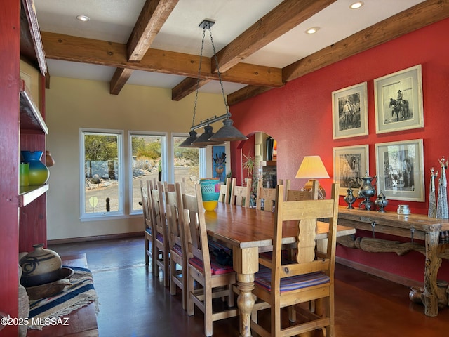 dining room featuring beam ceiling, recessed lighting, baseboards, and arched walkways