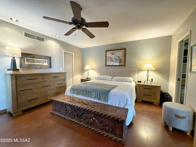 bedroom featuring finished concrete flooring, visible vents, and ceiling fan