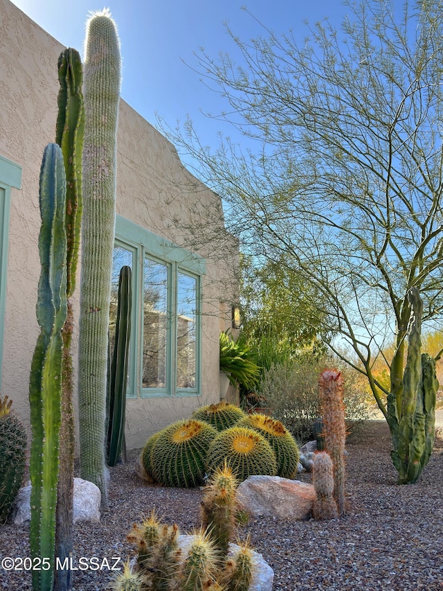 view of side of home with stucco siding