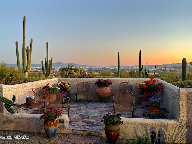 patio terrace at dusk with a mountain view