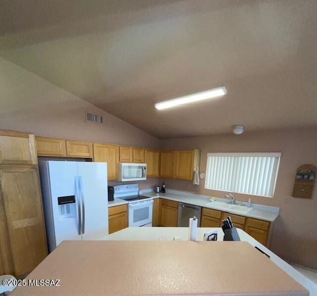 kitchen with visible vents, a sink, white appliances, light countertops, and vaulted ceiling