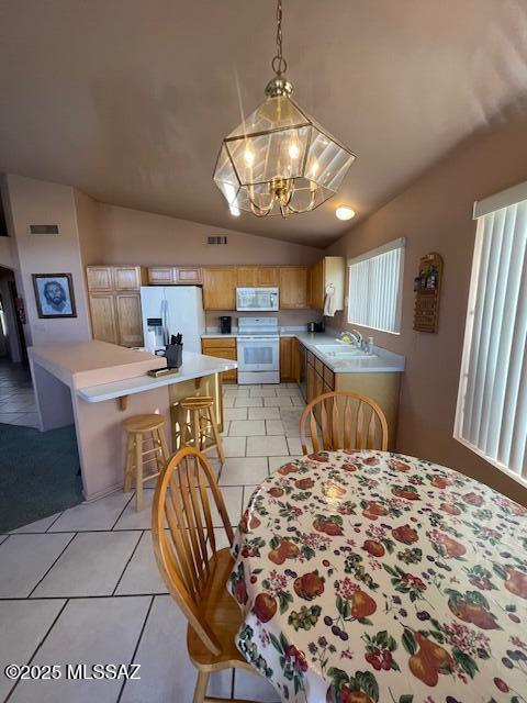 dining area featuring vaulted ceiling, light tile patterned floors, visible vents, and a chandelier