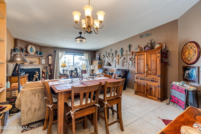 dining space with a notable chandelier, visible vents, and light tile patterned floors