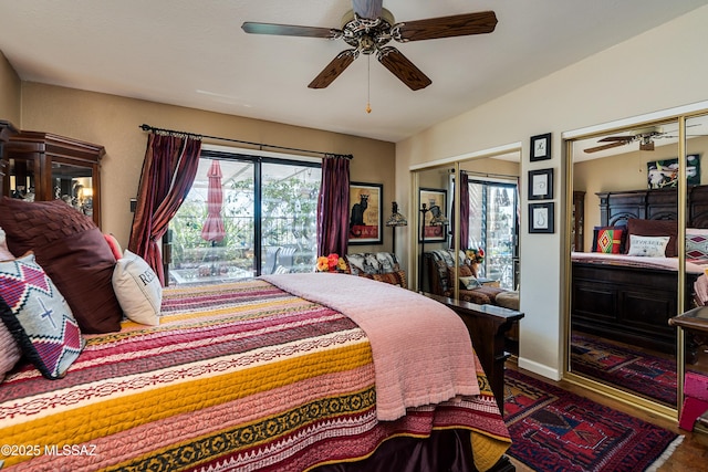 bedroom with baseboards, multiple closets, and ceiling fan