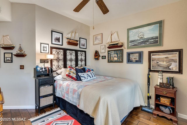 bedroom featuring ceiling fan, baseboards, and wood-type flooring