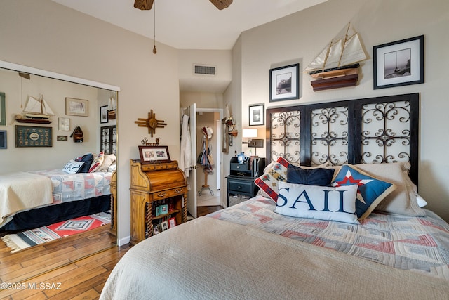 bedroom with hardwood / wood-style flooring, visible vents, and ceiling fan