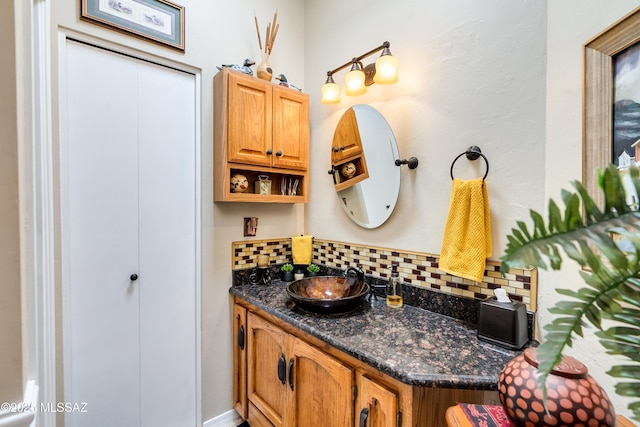 bathroom featuring decorative backsplash and vanity