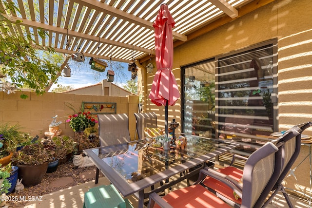 view of patio / terrace featuring outdoor dining space, fence, and a pergola