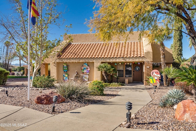 view of front of property featuring a tiled roof and stucco siding