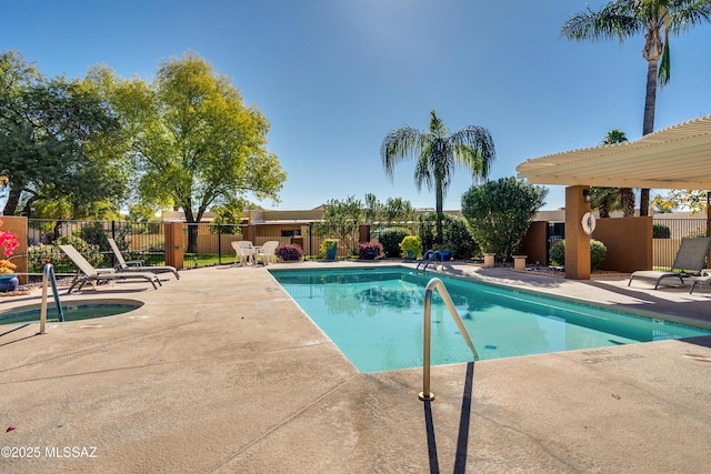 pool with a patio and fence