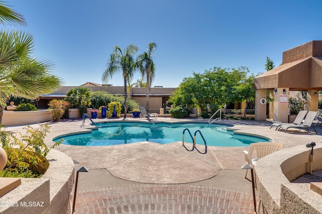 pool featuring a patio and fence