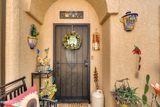 property entrance with stucco siding