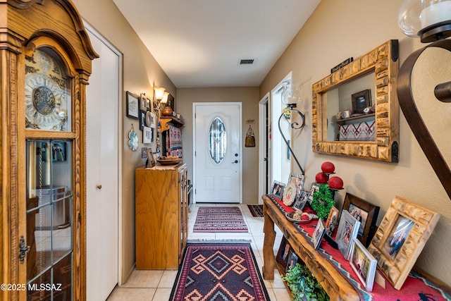 foyer with light tile patterned floors and visible vents