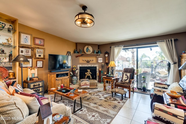 living room with light tile patterned flooring and a fireplace