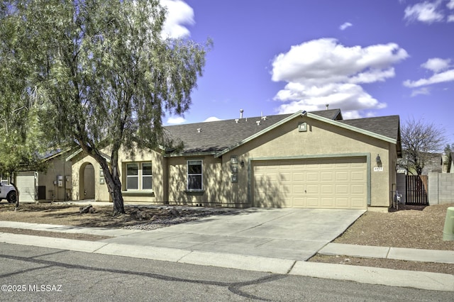 single story home with fence, an attached garage, a shingled roof, stucco siding, and concrete driveway