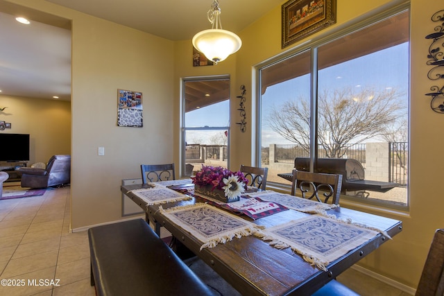 dining space featuring recessed lighting, baseboards, and light tile patterned flooring