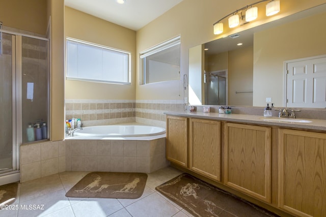 bathroom featuring a garden tub, a stall shower, a sink, tile patterned flooring, and double vanity