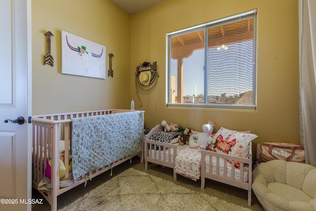 tiled bedroom with a nursery area