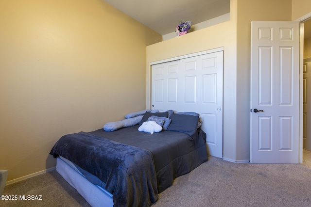 bedroom with carpet, baseboards, and a closet