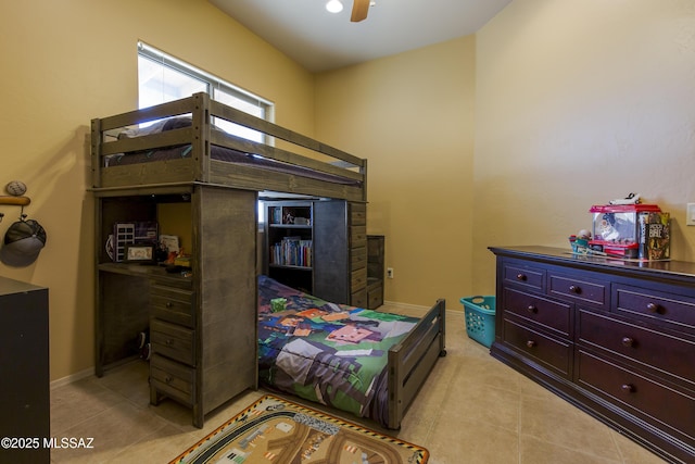 bedroom featuring light tile patterned floors, baseboards, and a ceiling fan