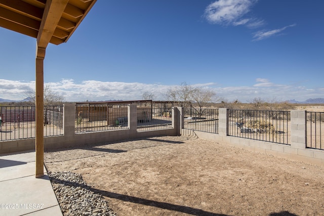 view of yard featuring a mountain view and fence