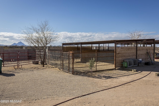 view of outbuilding with an outbuilding, an exterior structure, and a mountain view