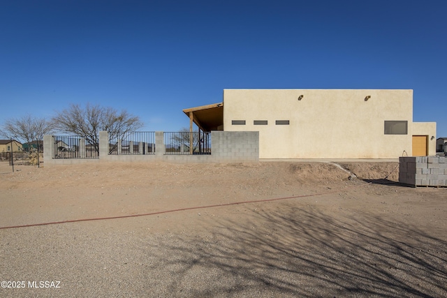 view of home's exterior featuring fence and stucco siding