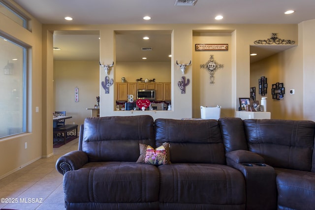 living room featuring light tile patterned flooring, recessed lighting, visible vents, and baseboards