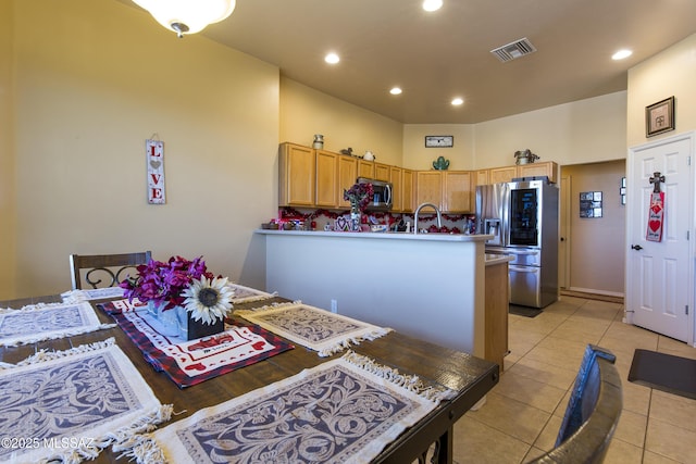 kitchen featuring light tile patterned floors, recessed lighting, a peninsula, and stainless steel appliances