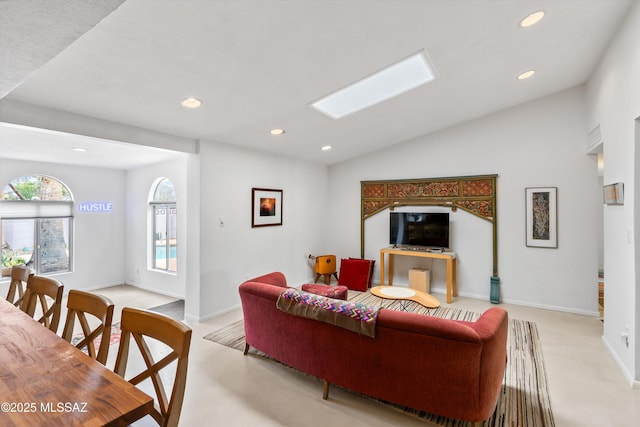 living room featuring vaulted ceiling, recessed lighting, and baseboards