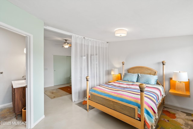 bedroom with concrete flooring and baseboards