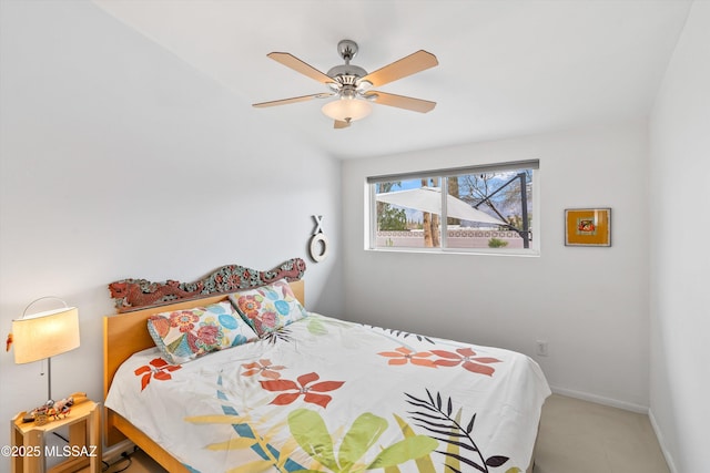 bedroom with baseboards and a ceiling fan