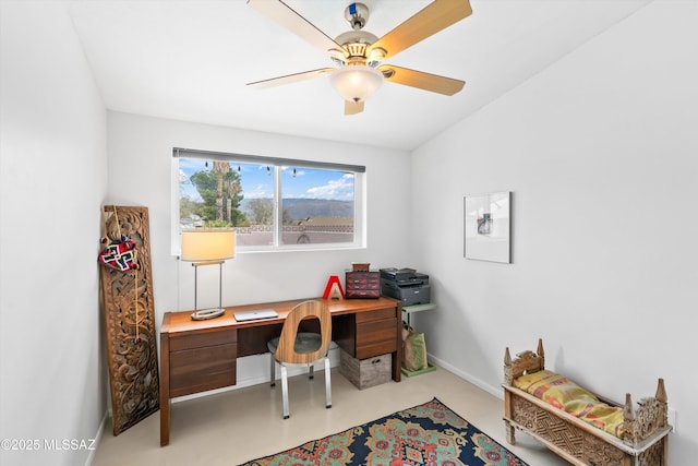 office space featuring ceiling fan, baseboards, and finished concrete floors