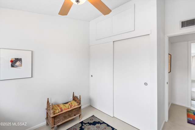 sitting room with a ceiling fan, visible vents, and finished concrete floors