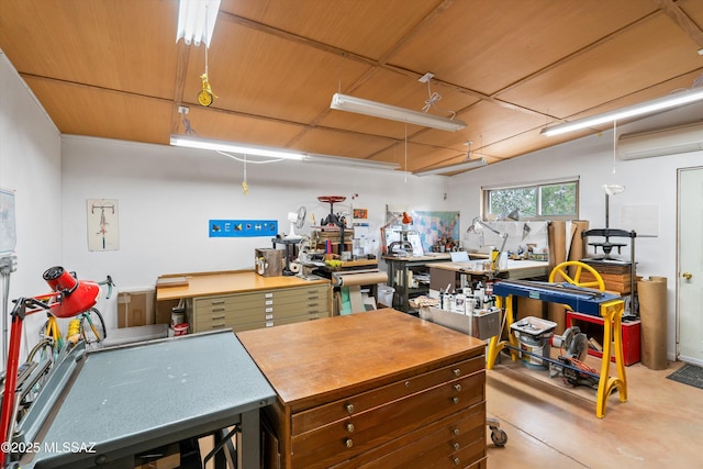 interior space with a workshop area and a wall mounted air conditioner